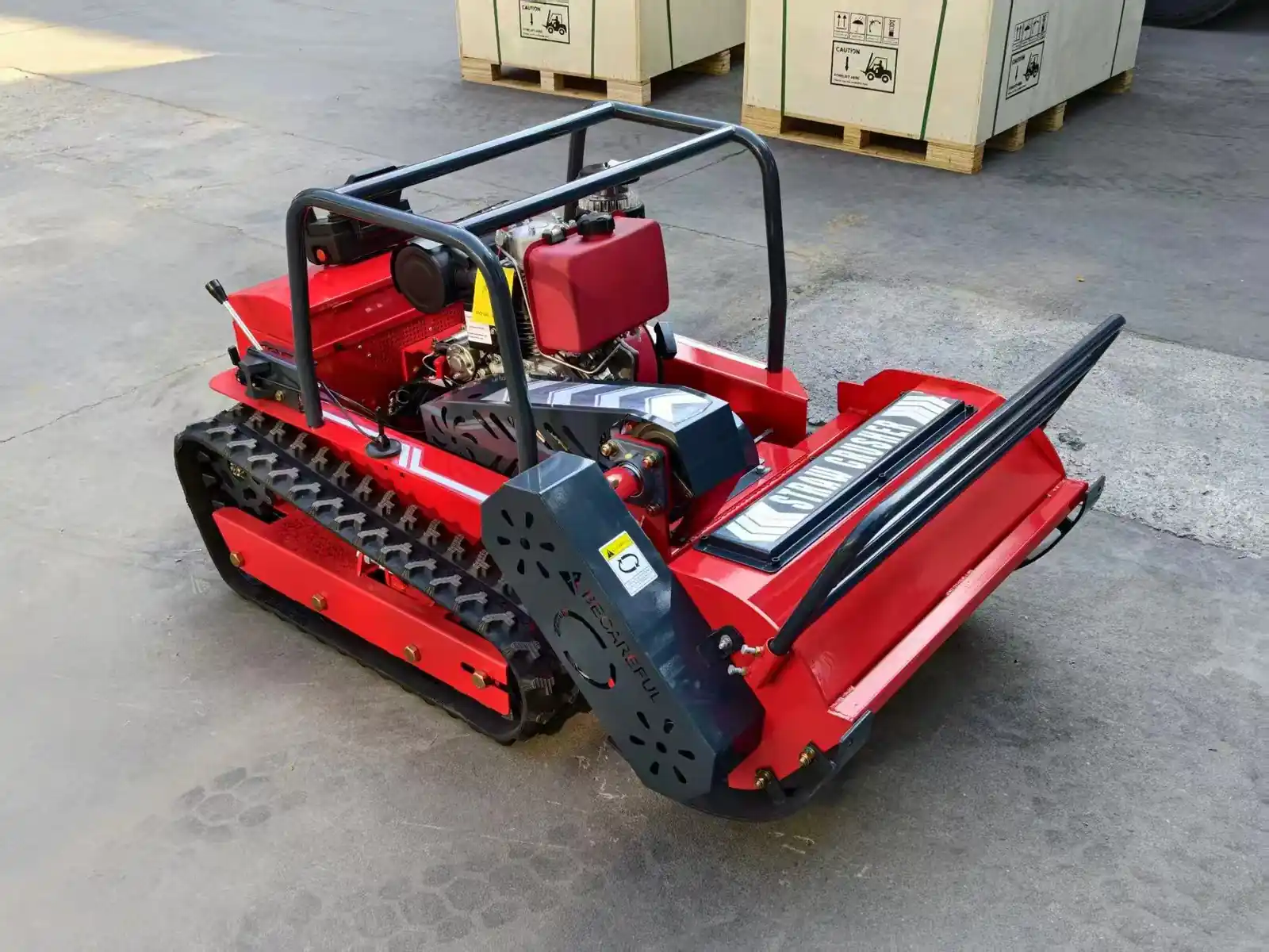Close view of a tracked mower cutting deck and drive components