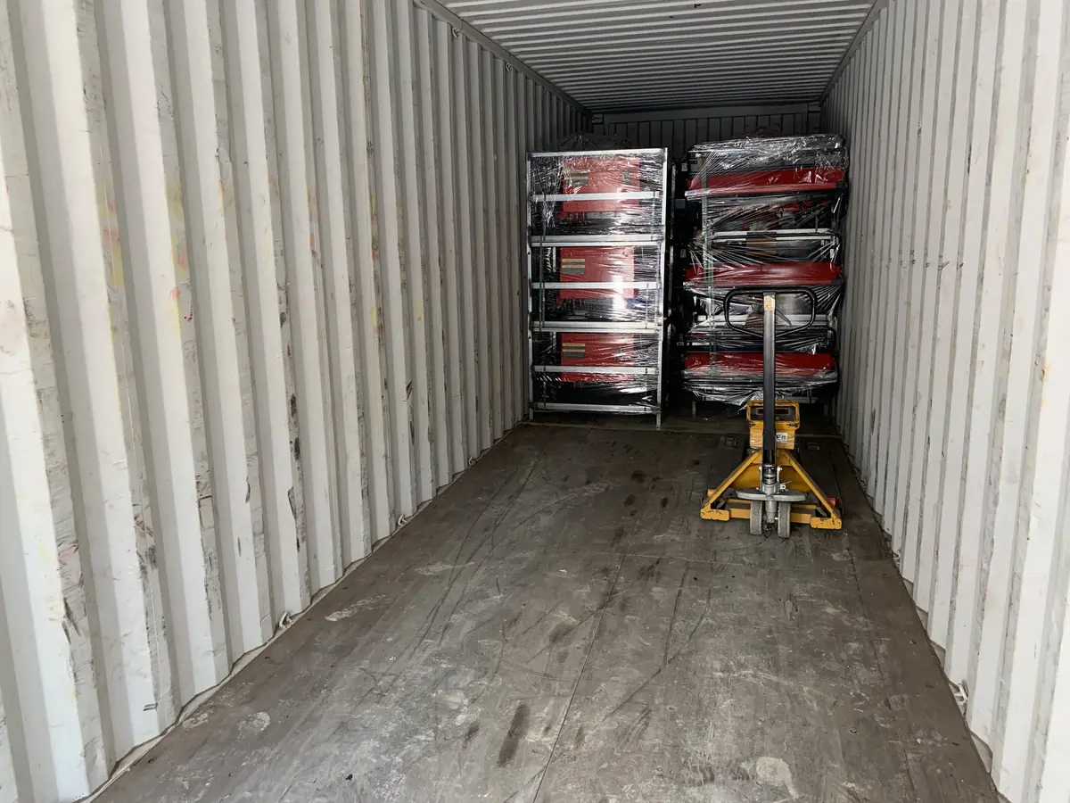 Wrapped mower units secured inside a shipping container
