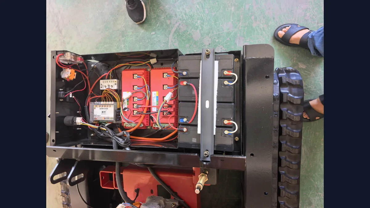Open remote mower battery and controller bay viewed from above